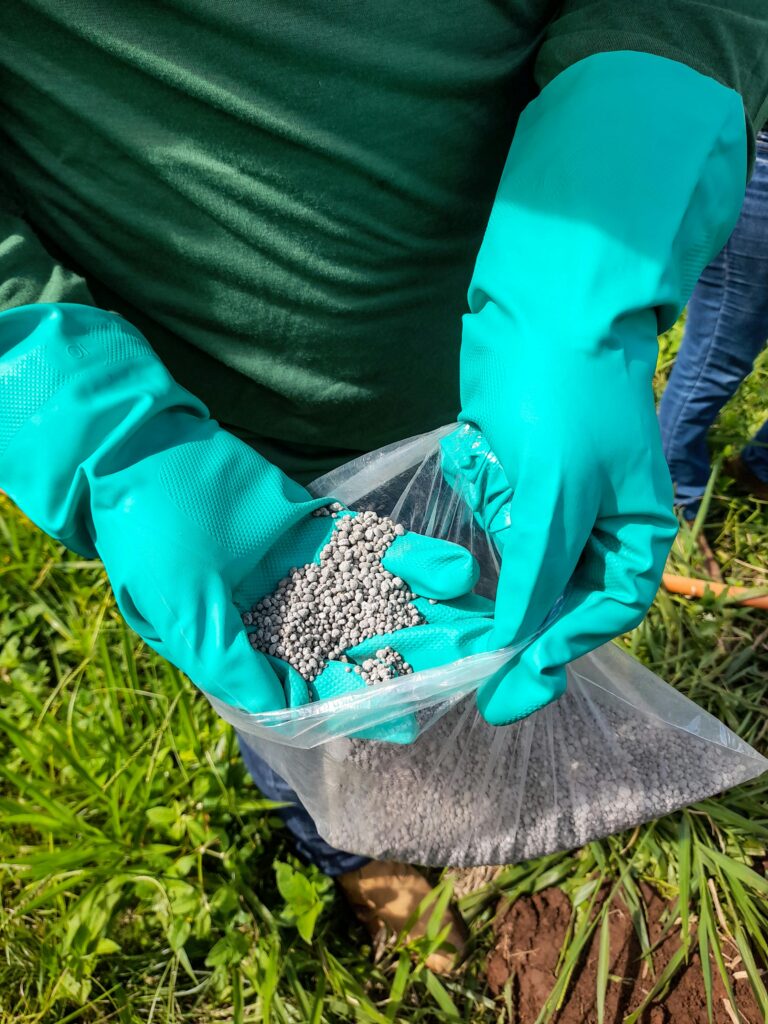 pexels-photo-25974981-25974981 Person Hands in Gloves Holding Bag with Soil